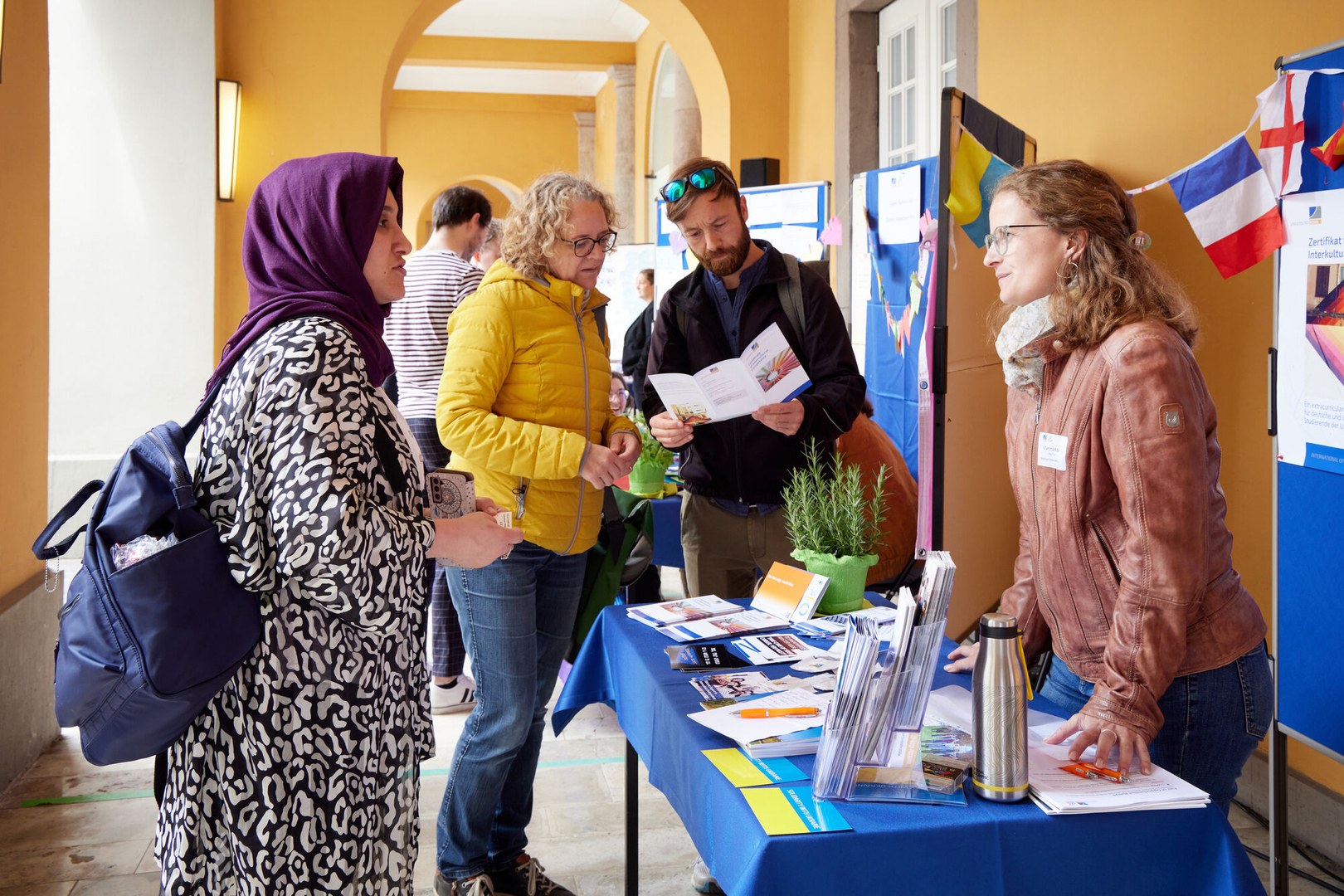 Photo of visitors to the Fair of Opportunities waiting at a stand